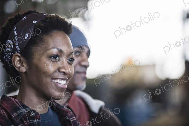 Black man and woman team of factory workers in a sheet metal factory