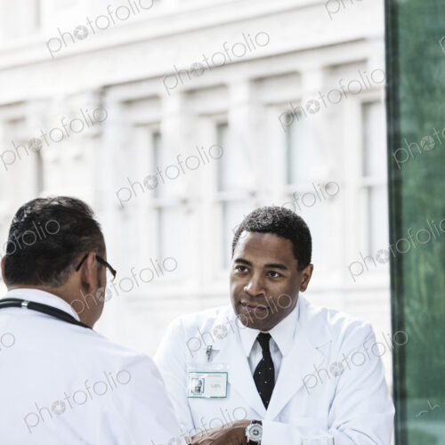 Black man doctor in a lunch time discussion with a colleague. Black man doctor in a lunch time discussion with a colleague.