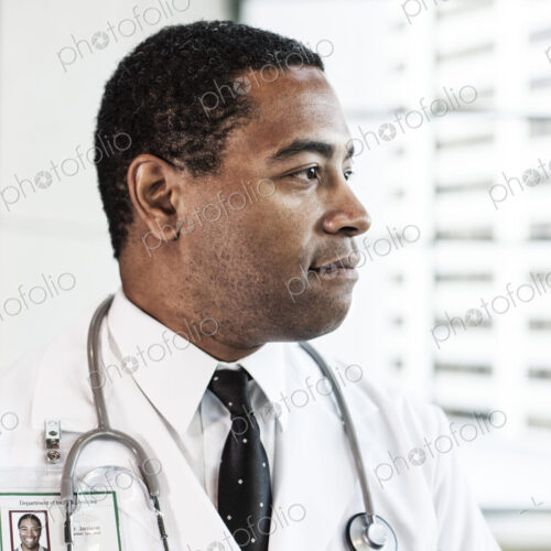 Black man doctor in lab coat with a stethescope.