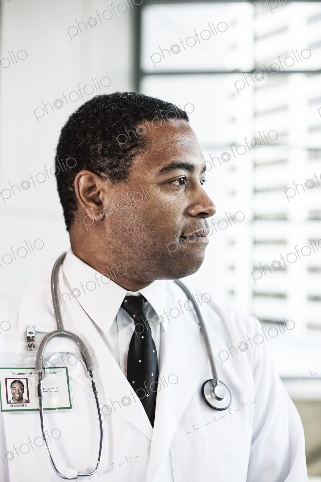 Black man doctor in lab coat with a stethescope.