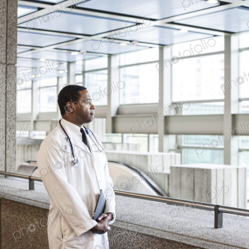 Black man doctor in lab coat with a stethescope. Black man doctor in lab coat with a stethescope.