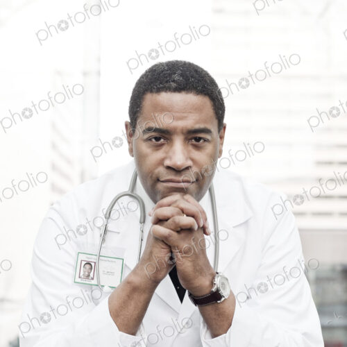 Black man doctor in lab coat with a stethescope.