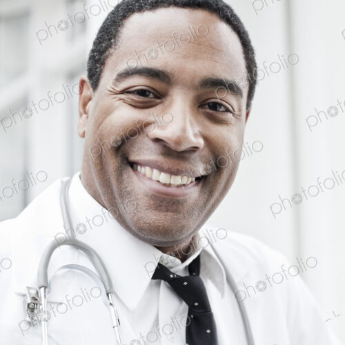 Black man doctor in lab coat with a stethoscope. Black man doctor in lab coat with a stethoscope.