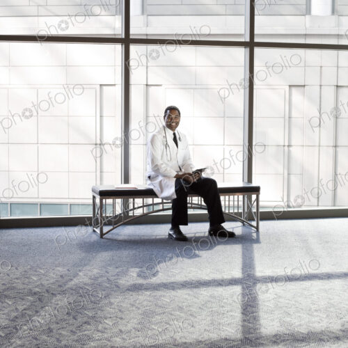 Black man doctor in lab coat with stethescope.