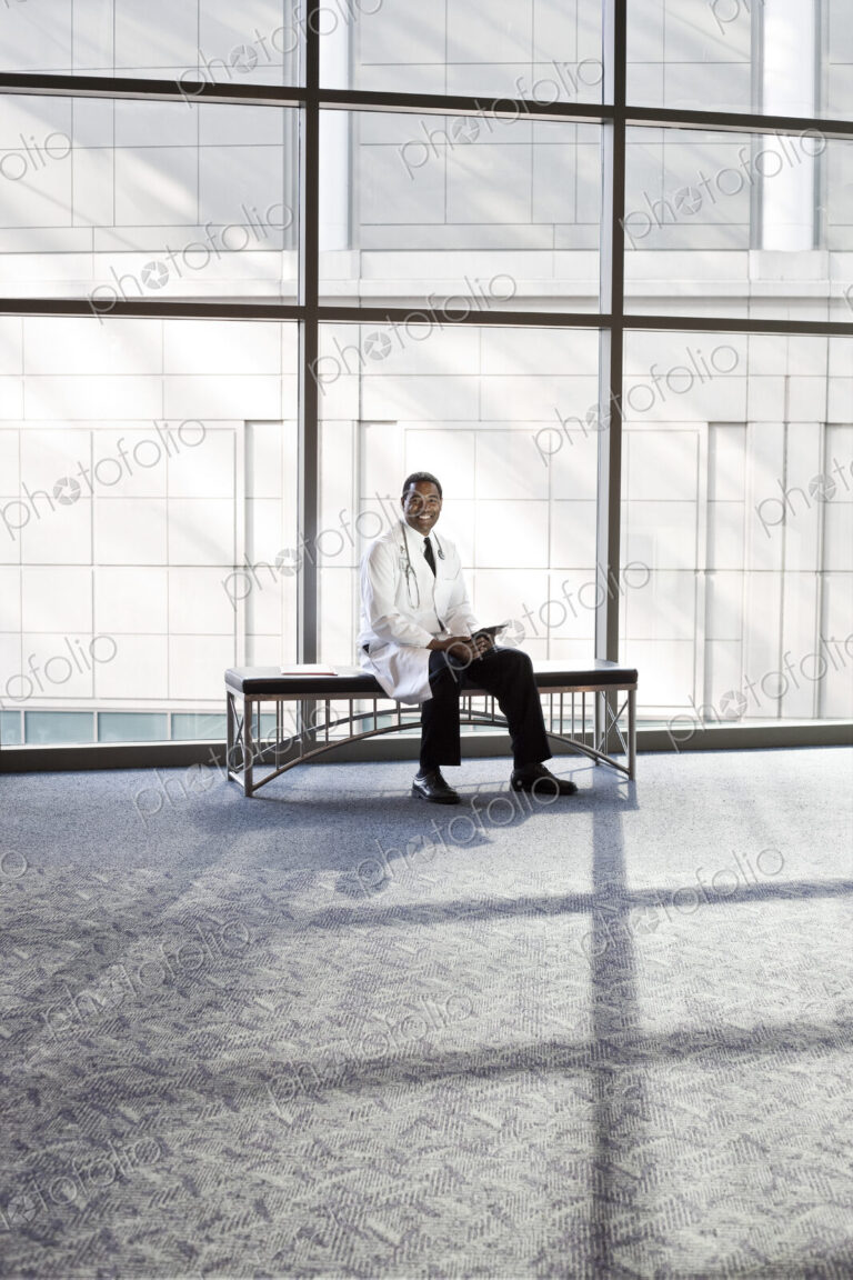 Black man doctor in lab coat with stethescope.