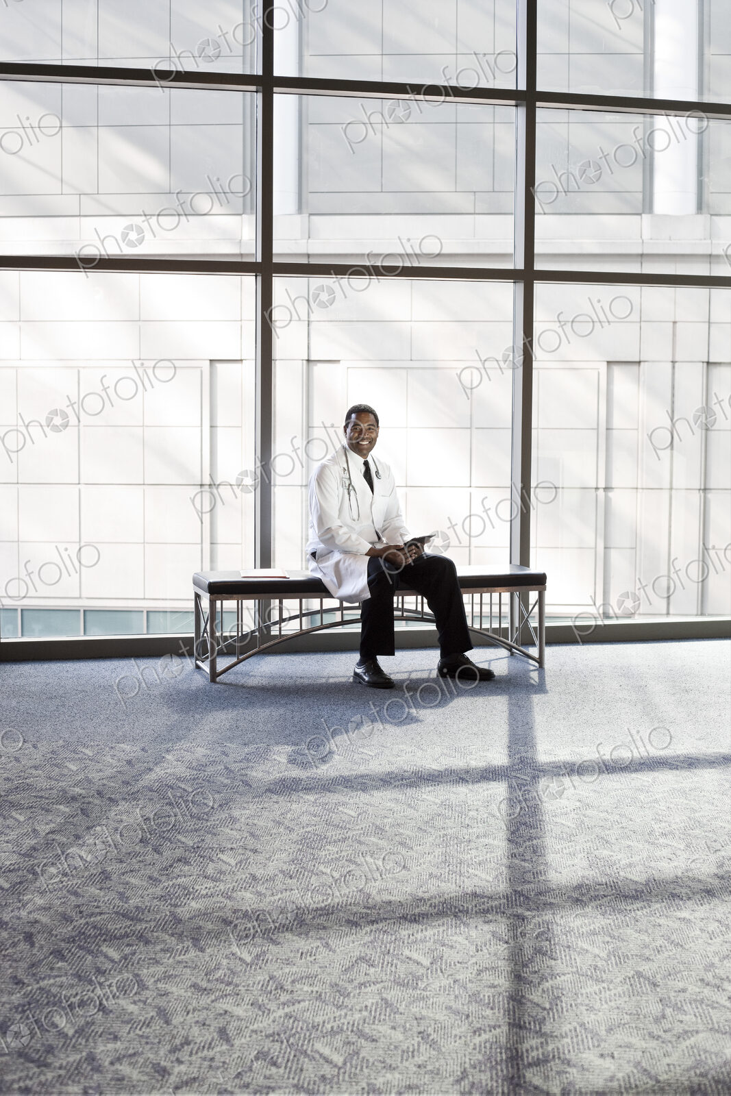 Black man doctor in lab coat with stethescope.