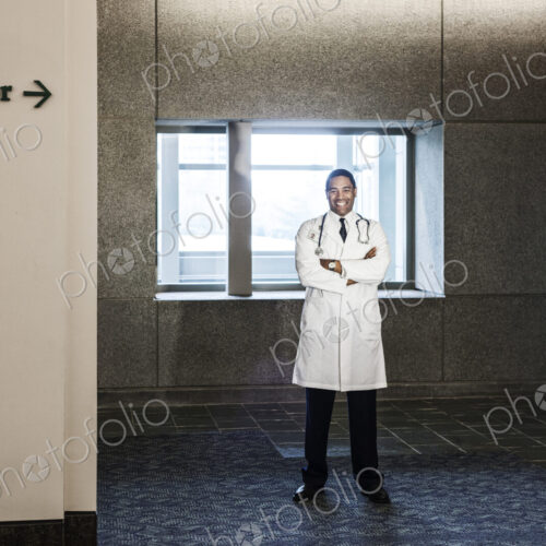 Black man doctor standing in hospital hallway. Black man doctor standing in hospital hallway.