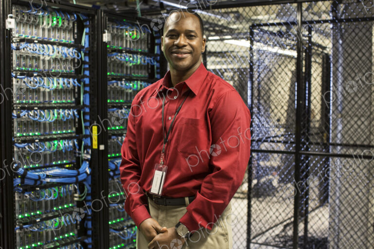 Black man technician in a computer server farm.