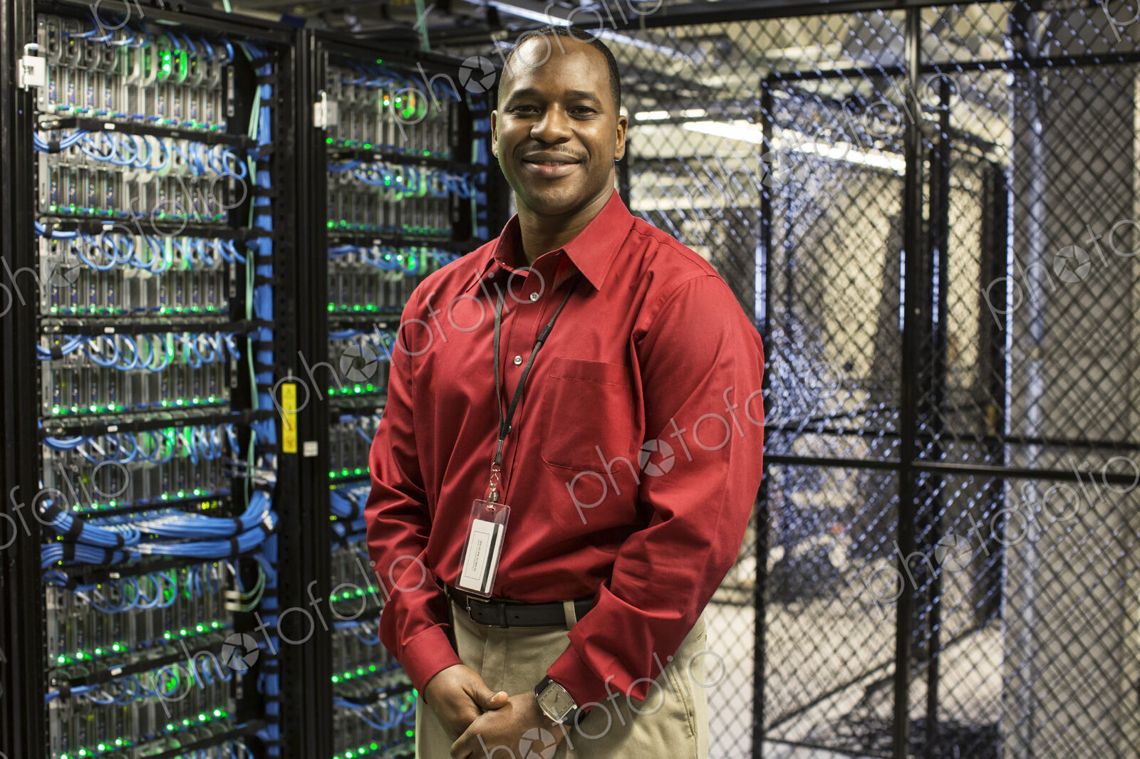 Black man technician in a computer server farm.