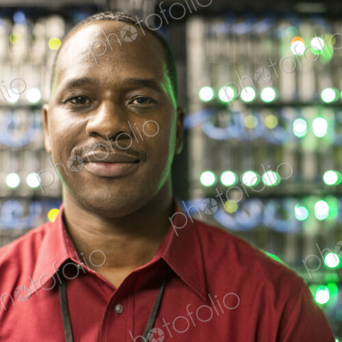 Black man technician in a computer server farm. Black man technician in a computer server farm.