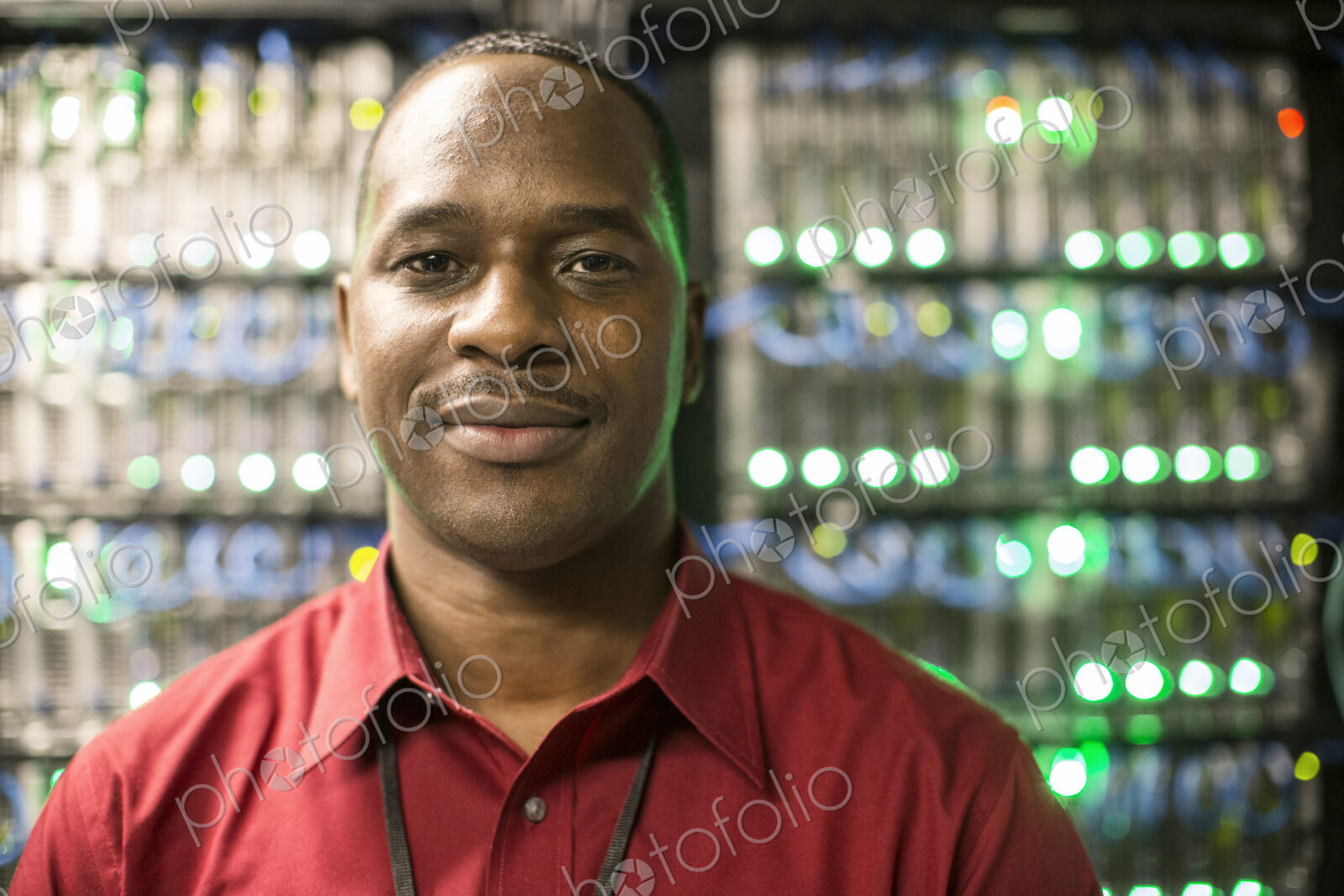 Black man technician in a computer server farm.