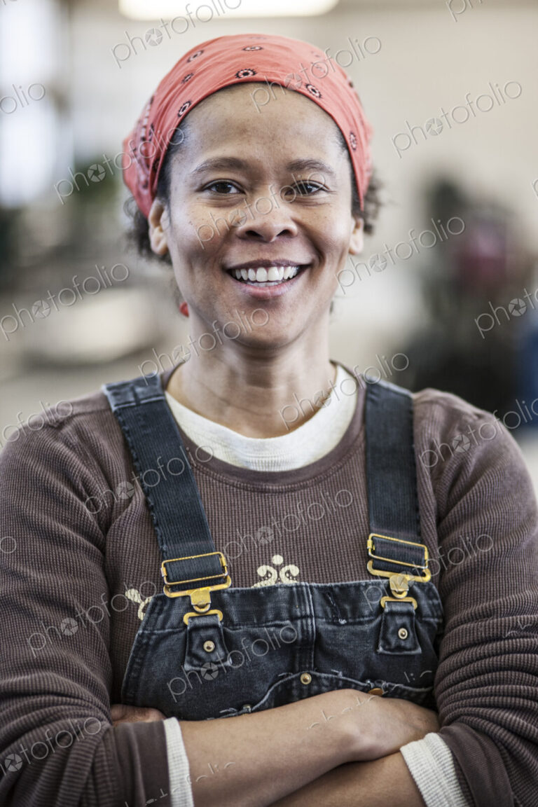 Black woman factory worker in a sheet metal factory.