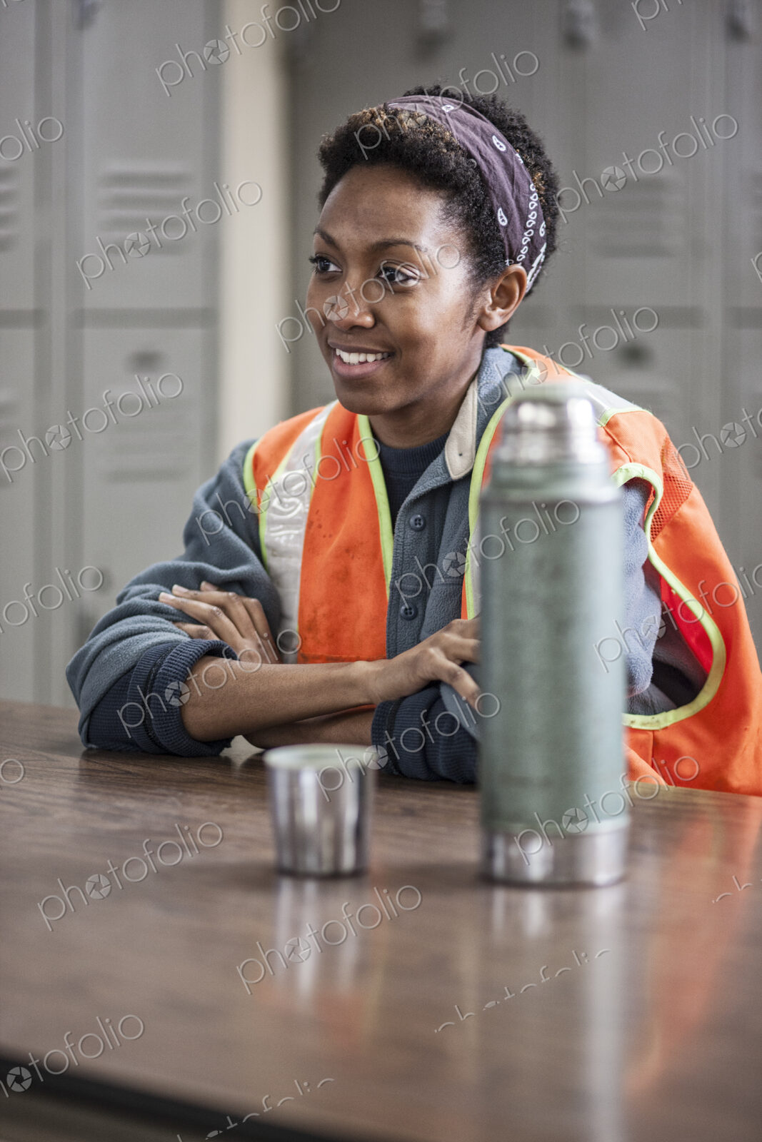 Black woman factory worker wearing a safety vest and taking a break in a factory break…