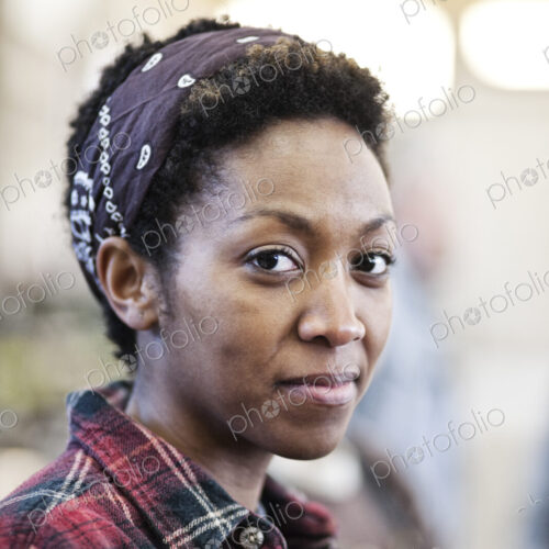 Black woman wearing a bandana in a factrory. Black woman wearing a bandana in a factrory.