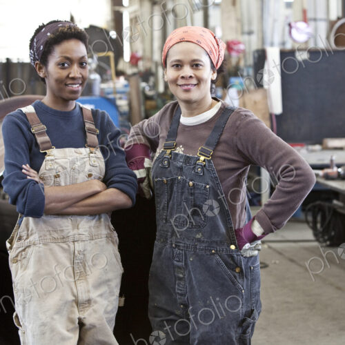 Black women team of factory workers in a sheet metal factory.