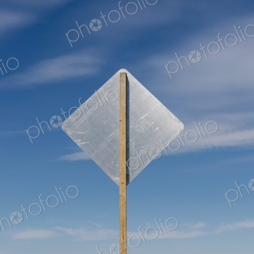 Blank side of a road sign, blue sky in background Blank side of a road sign, blue sky in background