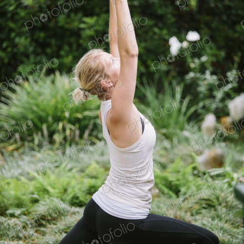 Blond woman doing yoga in a garden. Blond woman doing yoga in a garden.