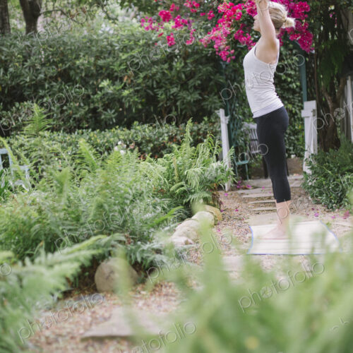 Blond woman doing yoga in a garden. Blond woman doing yoga in a garden.