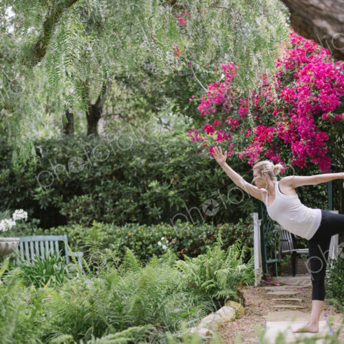 Blond woman doing yoga in a garden. Blond woman doing yoga in a garden.
