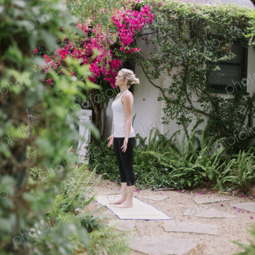 Blond woman doing yoga in a garden. Blond woman doing yoga in a garden.