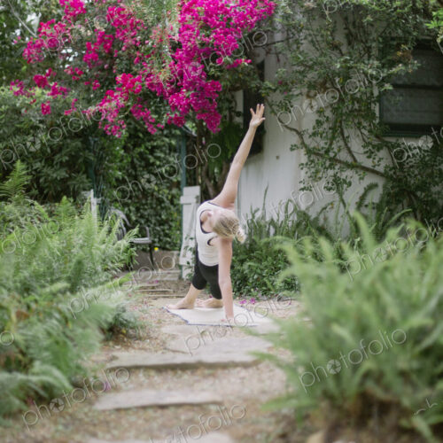 Blond woman doing yoga in a garden. Blond woman doing yoga in a garden.