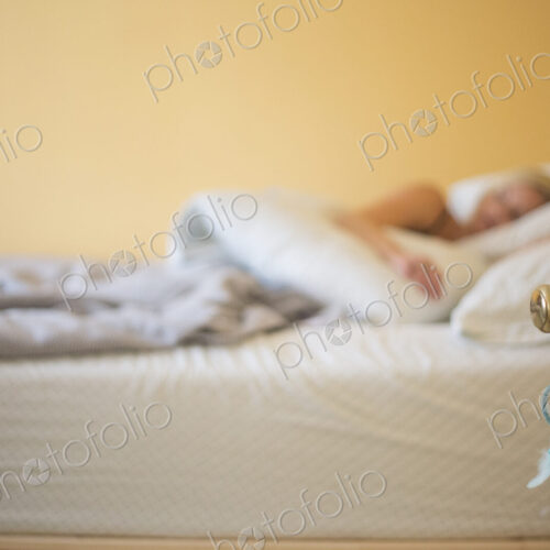 Blond woman sleeping in a bed.