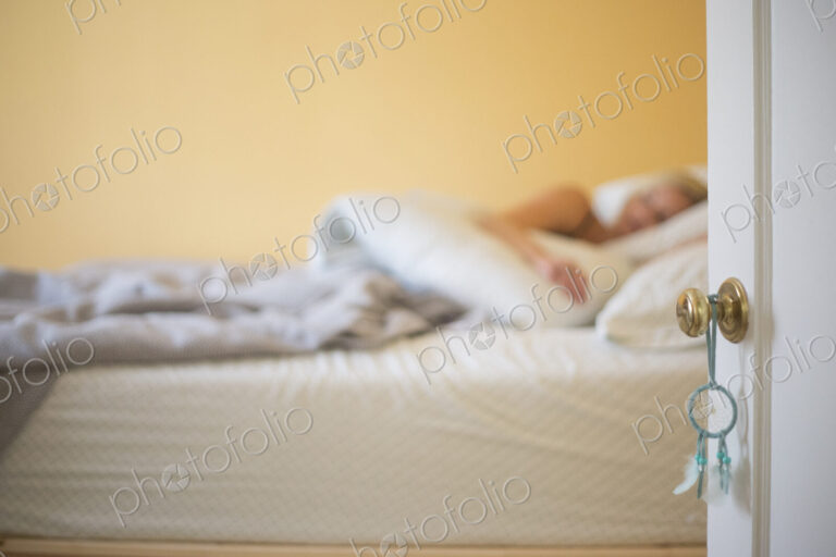 Blond woman sleeping in a bed.