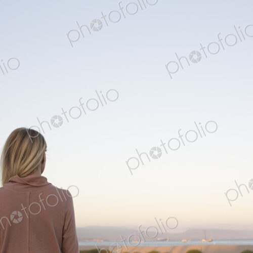 Blond woman standing at the ocean. Blond woman standing at the ocean.