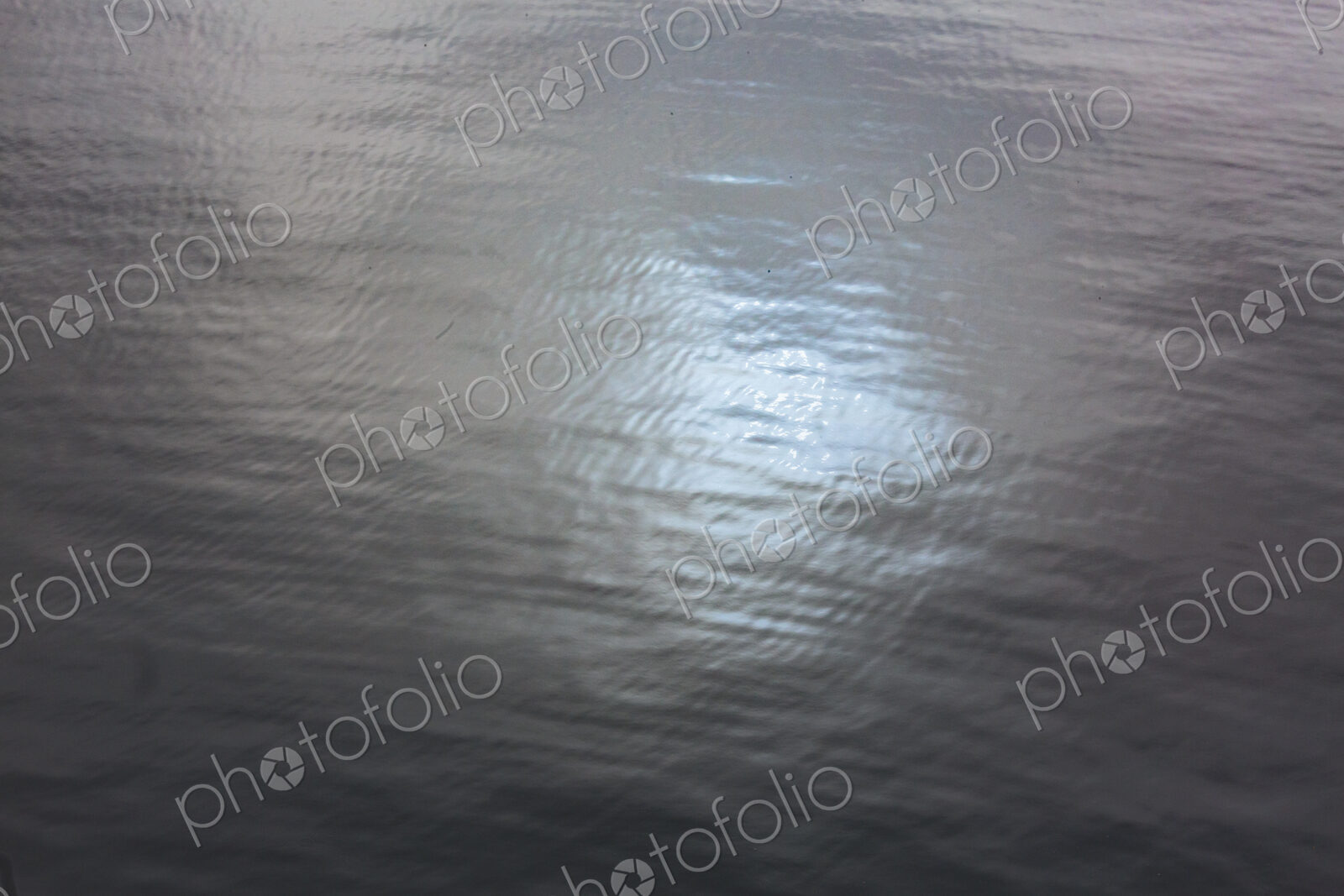 Blue sky reflection on the waters of Puget Sound, in fog.