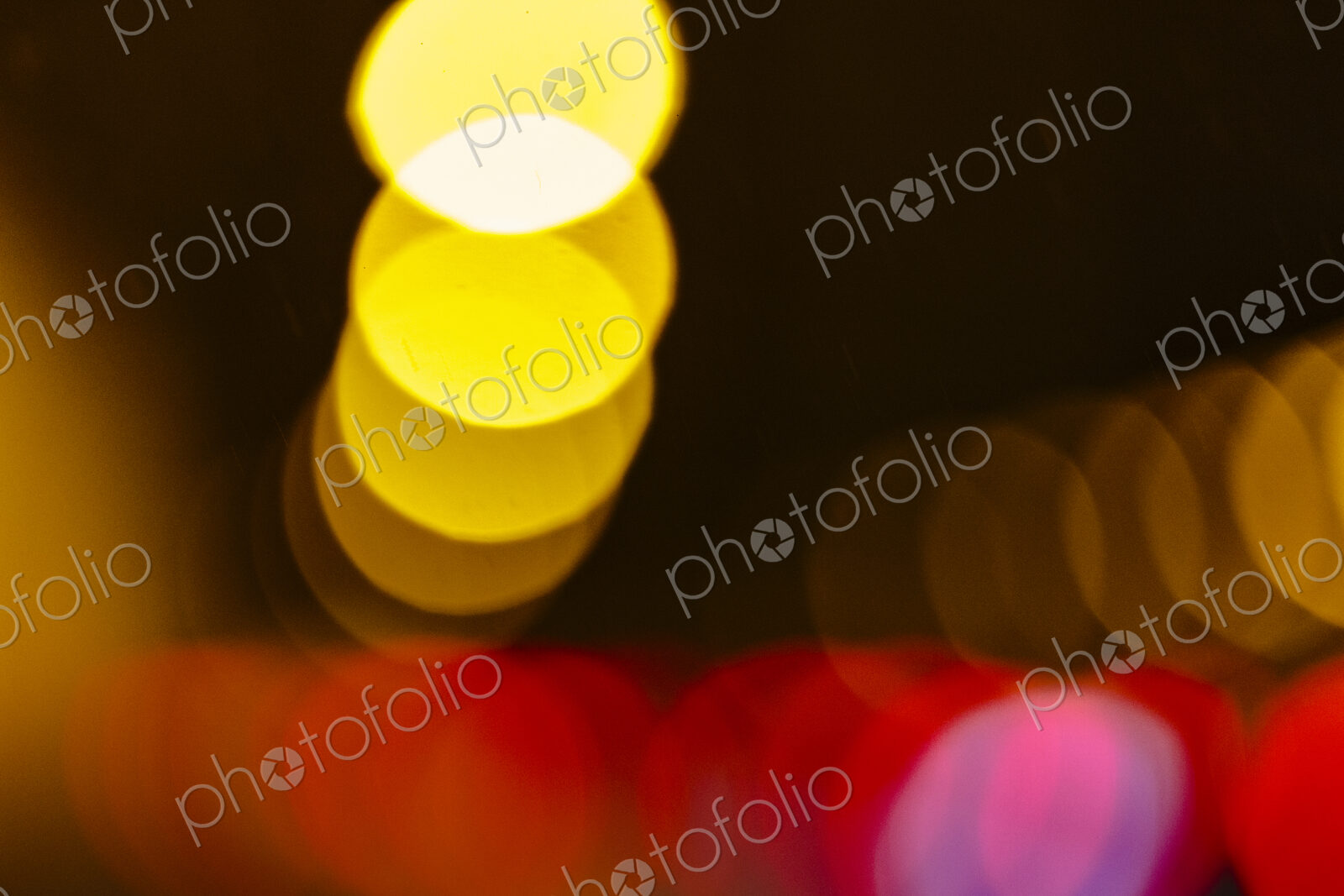 Blurred headlights and tail lights at night, abstract patterns.