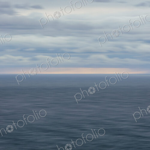 Blurred motion abstract of ocean, horizon and stormy sky at dusk Blurred motion abstract of ocean, horizon and stormy sky at dusk