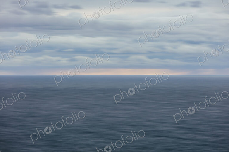 Blurred motion abstract of ocean, horizon and stormy sky at dusk