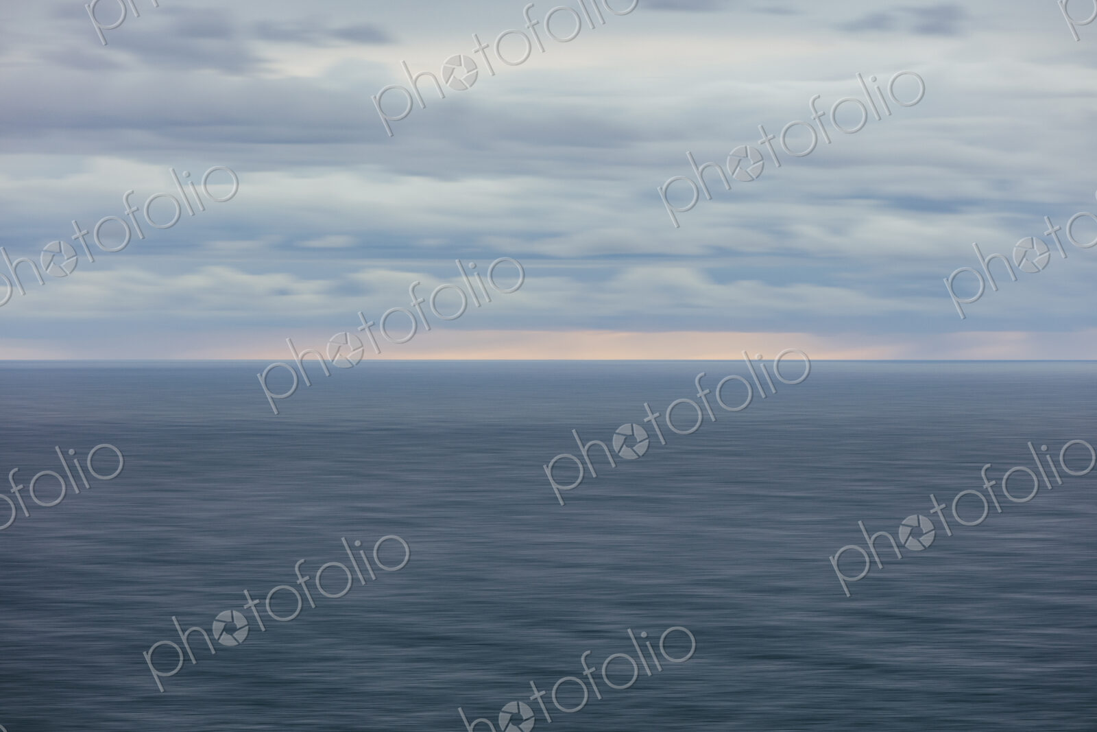 Blurred motion abstract of ocean, horizon and stormy sky at dusk