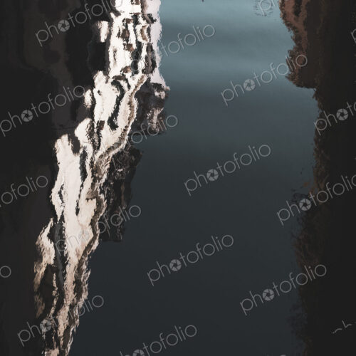 Blurred reflection of the facades of buildings lining a canal in Venice, Veneto, Italy.