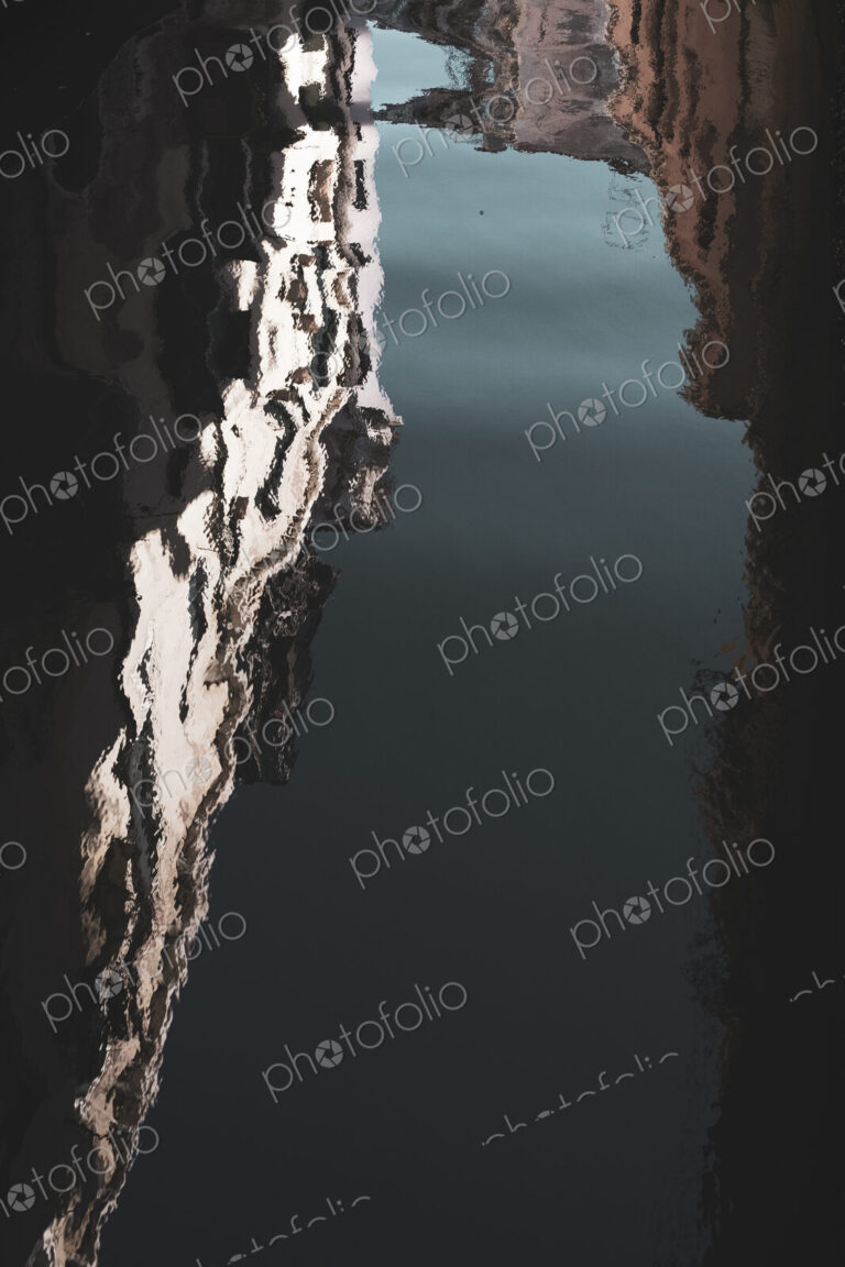 Blurred reflection of the facades of buildings lining a canal in Venice, Veneto, Italy.