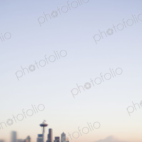 Blurred urban skyline with blue sky above. Blurred urban skyline with blue sky above.