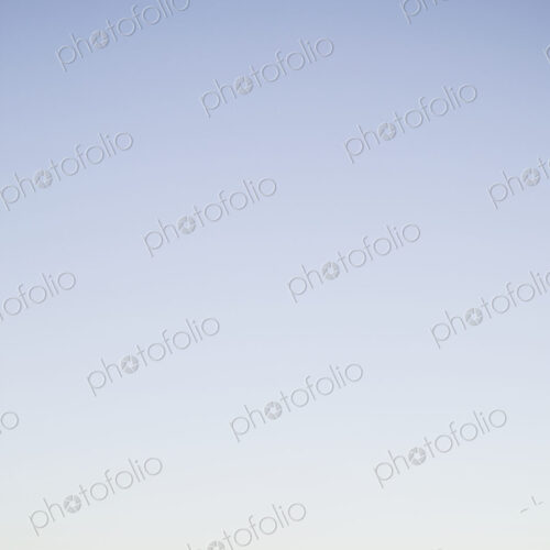 Blurred urban skyline with blue sky above. Blurred urban skyline with blue sky above.