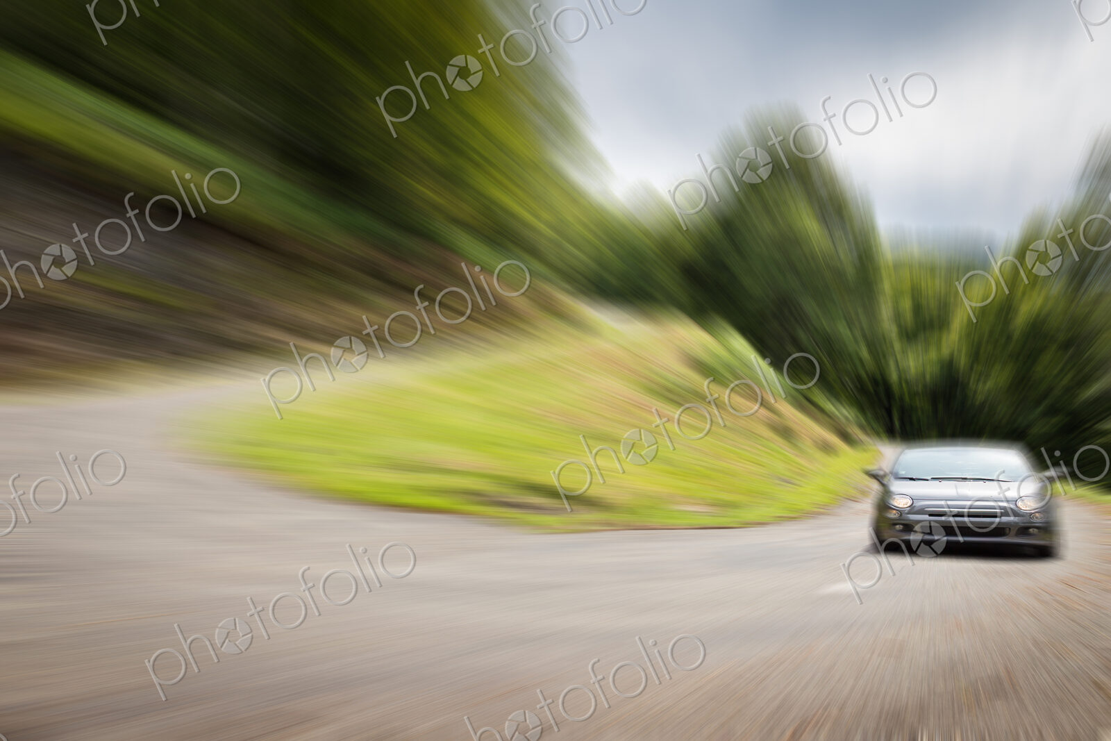 Blurred view of car driving on curved road
