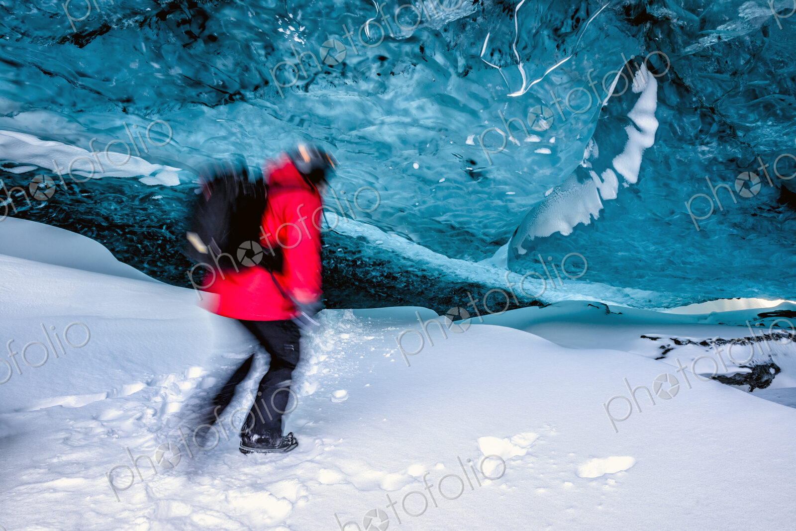 Blurred view of hiker walking in ice cave