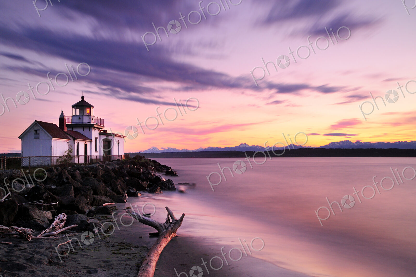 Blurred view of ocean waves on lighthouse beach at sunset
