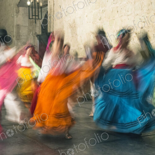 Blurred view of women dancing in traditional costumes, with bright coloured skirts Blurred view of women dancing in traditional costumes, with bright coloured skirts