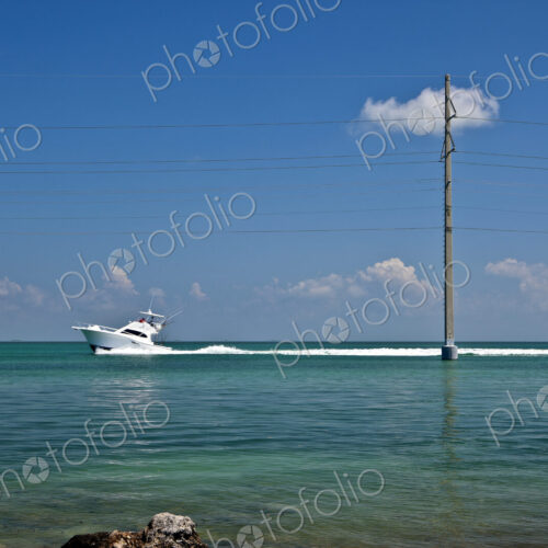 Boat Driving Past a Utility Pole
