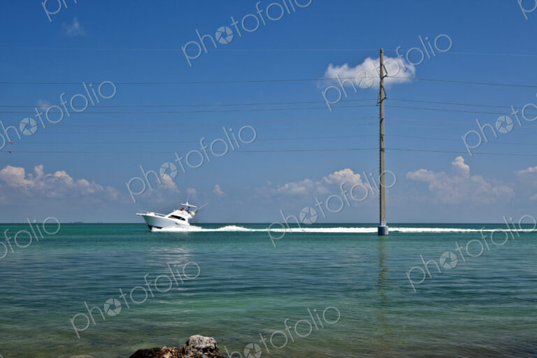 Boat Driving Past a Utility Pole