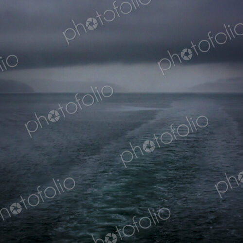 Boat wake behind the San Juan Islands ferry, low cloud and a stormy outlook. Boat wake behind the San Juan Islands ferry, low cloud and a stormy outlook.
