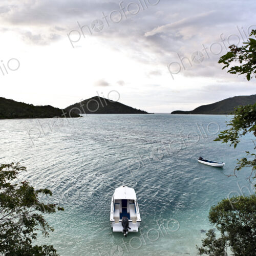 Boats Anchored Offshore Of A Tropical Island