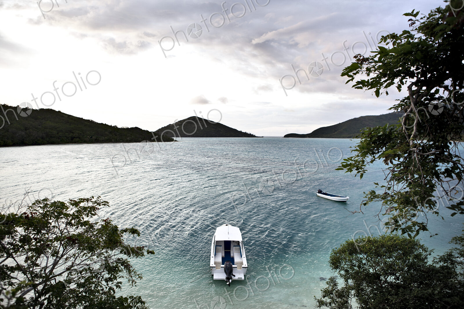 Boats Anchored Offshore Of A Tropical Island