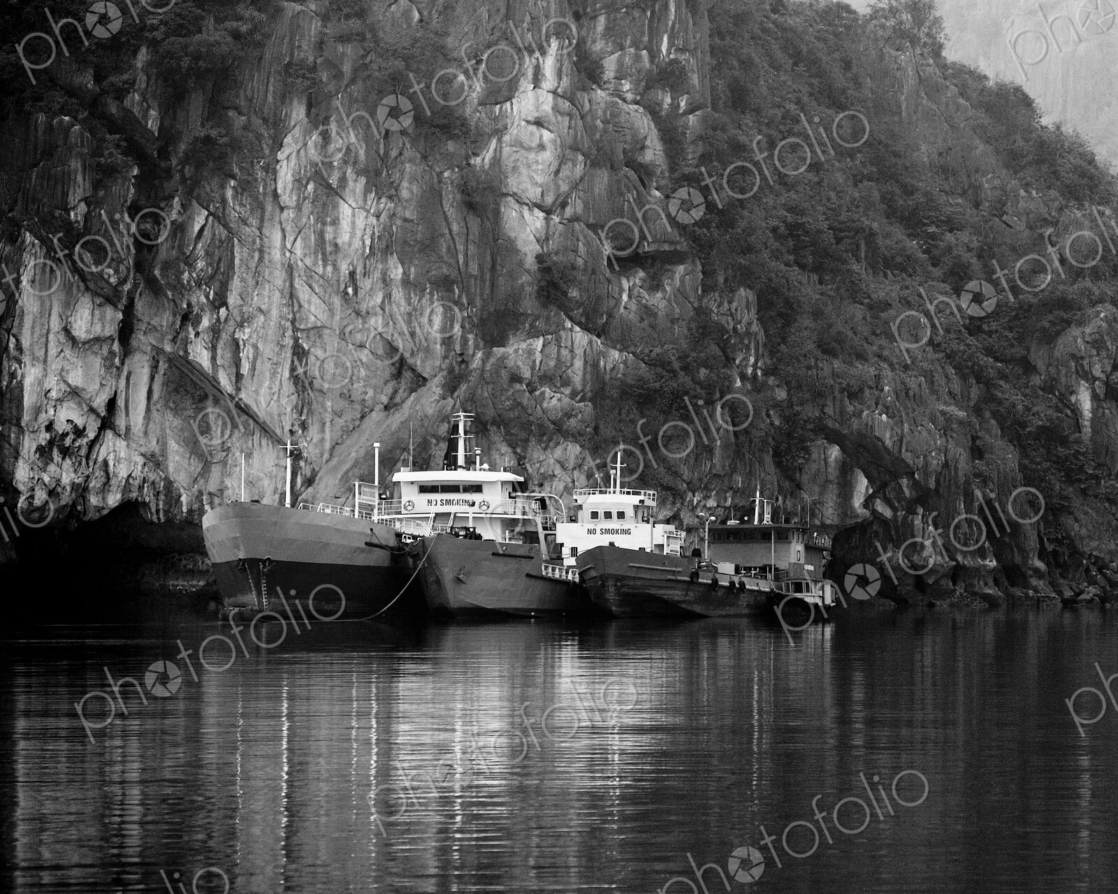 Boats Docked by a Cliff
