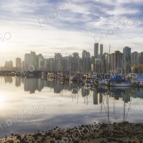 Boats moored in Vancouver harbour with skyscrapers behind. Boats moored in Vancouver harbour with skyscrapers behind.