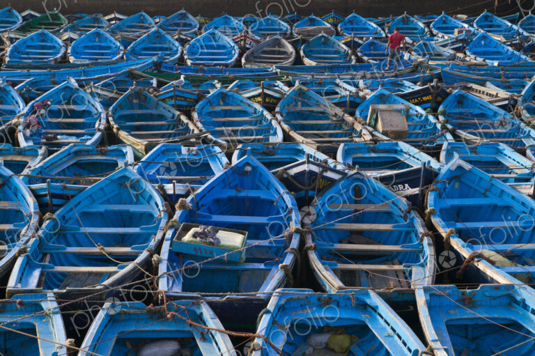 Boats moored very close together in the harbor of Essaouira, Morocco