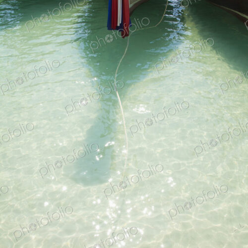 Boats moored with flag and rope in ocean. Boats moored with flag and rope in ocean.